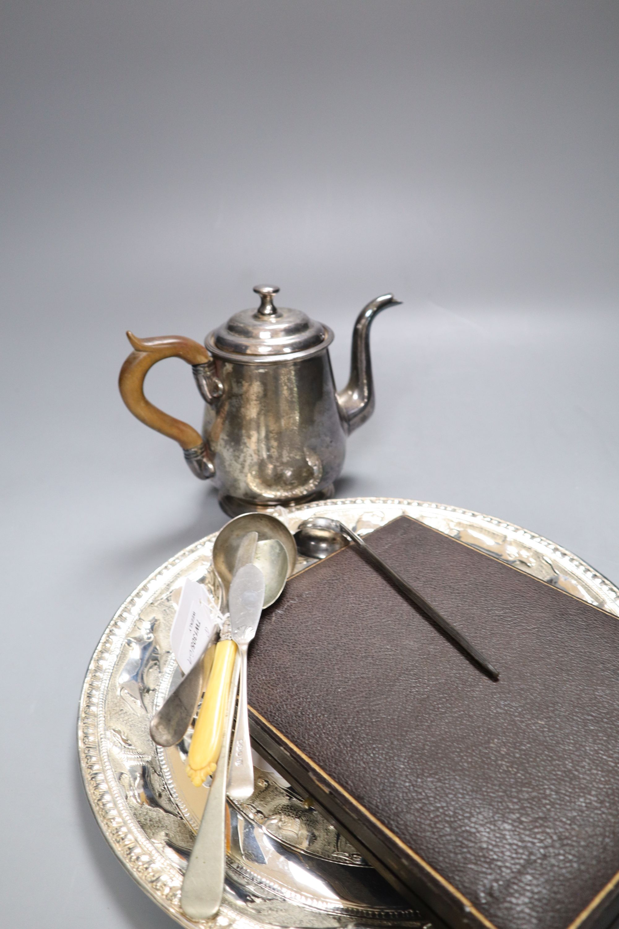 An Eastern embossed plated tray, a cased plated nut and grape set, a plated coffee pot, a silver sauce ladle and sundries